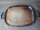 a silver tray with a handle on a table