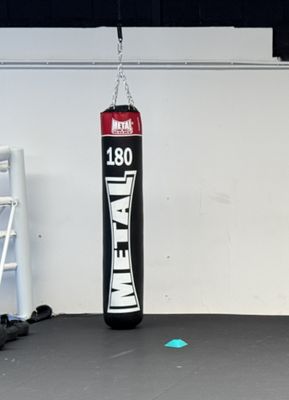 a punching bag hanging from a chain in a gym