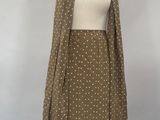 beige and white polka dot dress and scarf on a mannequin dummy