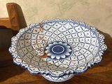 a blue and white bowl sitting on a wooden table