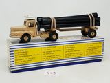 a toy truck with a large load of logs on top of it