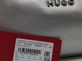 silver purse with a red tag on it sitting on a white surface
