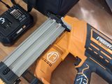 a cord nailer and two other tools on a table