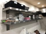 many pots and pans on the shelves in the kitchen