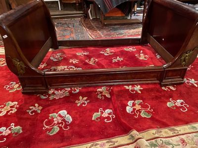 a bed that has a red carpet on the floor