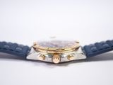 a close up of a watch on a white surface