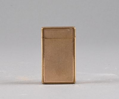 an image of a gold lighter sitting on top of a white surface