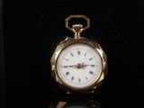 a gold pocket watch with roman numerals on the face