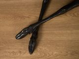 two spoons that are sitting on a wooden table