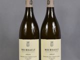 two bottles of wine sitting next to each other on a table