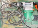 a green box with tools inside of it on the floor
