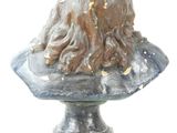 a statue of a woman with long hair on top of a bust