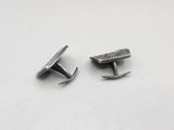 pair of silver plated cufflinks on a white surface