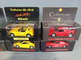 four different models of cars are in boxes on a table