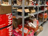many boxes and boxes on the shelves in the room