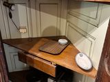 a wooden shelf in the corner of a room