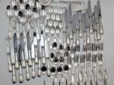 a lot of silver spoons and forks on the table