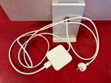 an apple macbook pro with charger and ear buds