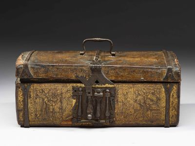 an old wooden box with a latch on top of it