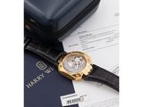the watch is sitting on top of a piece of paper next to a case