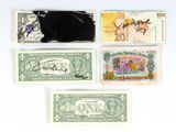 four different types of paper money sitting on top of a white surface