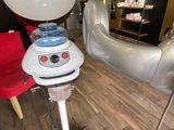 a hair dryer sitting on top of a stand in a room