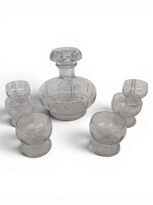a lot of glasses and a decanter on the table