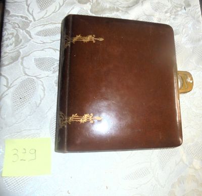 a brown leather book with gold writing on it