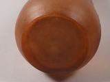 a brown vase sitting on a table with a white background
