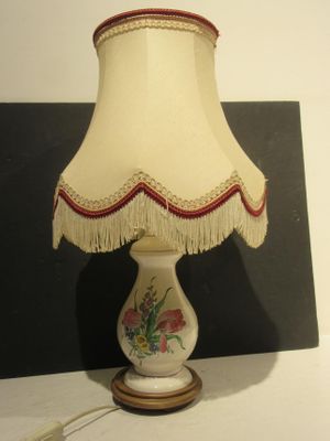 a lamp that is sitting on a table next to a picture