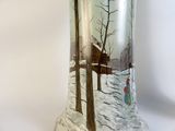 a glass vase with a picture of a person in the snow
