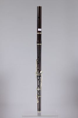 a close up of a clarinet on a stand with a white background
