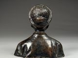 a close up of a statue of a person with a hat on