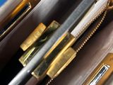a purse with a pen and a pencil inside of it