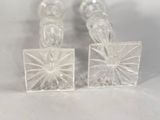 pair of clear glass candlesticks with a starburst design