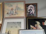 many framed pictures on the wall of this room