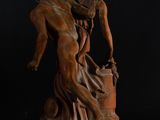 an image of a statue of a man holding a woman ' s head