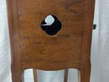 a wooden chair with a hole in the back of it