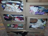 a carton filled with shoes and shoes on top of a carpet