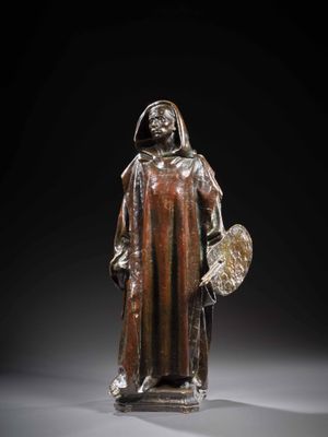 une statue en bronze représentant un homme tenant un bouclier et un bouclier
