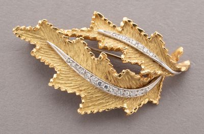 an image of a gold leaf brooch with diamonds on it
