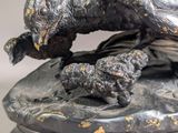 a statue of a bird with a baby bird on it ' s back