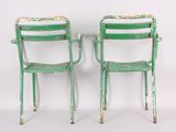 these are two green chairs sitting next to each other on a white surface