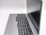 a silver laptop computer sitting on top of a white table