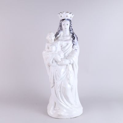 white statue of a woman holding a baby in her arms