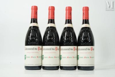 four bottles of red wine are lined up on a table