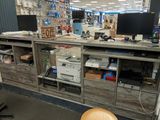 a desk with a computer monitor and a printer on it