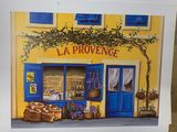a picture of a painting of a storefront with baskets of flowers
