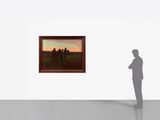 a man standing in front of a painting in an empty room