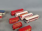 a lot of toy buses that are sitting on the floor